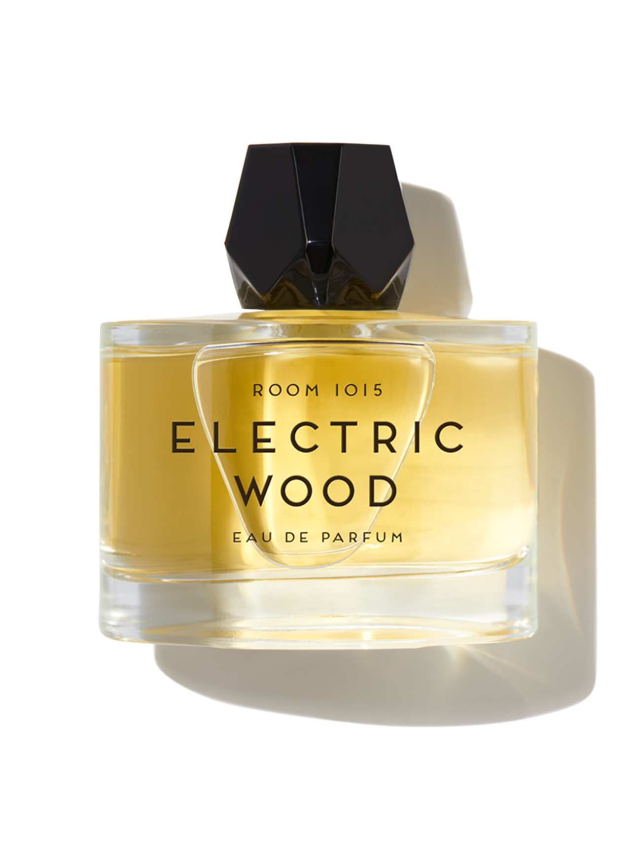 Perfume bottle labeled 'Electric Wood' by Room 1015 on a white background