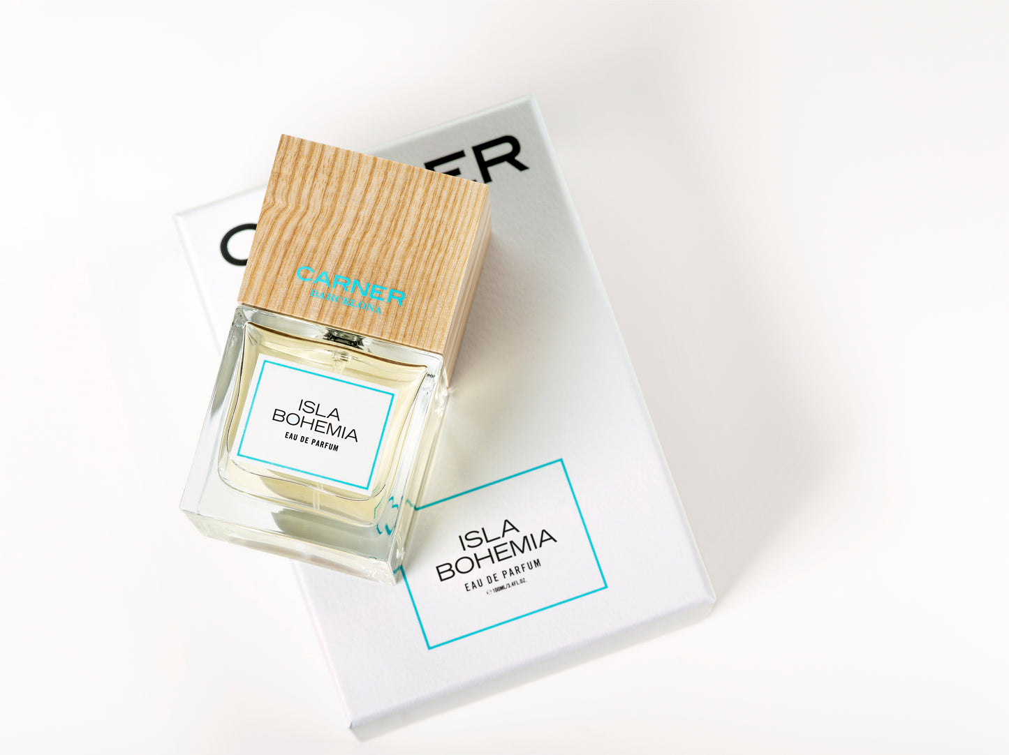 Perfume bottle with wooden cap on a white surface