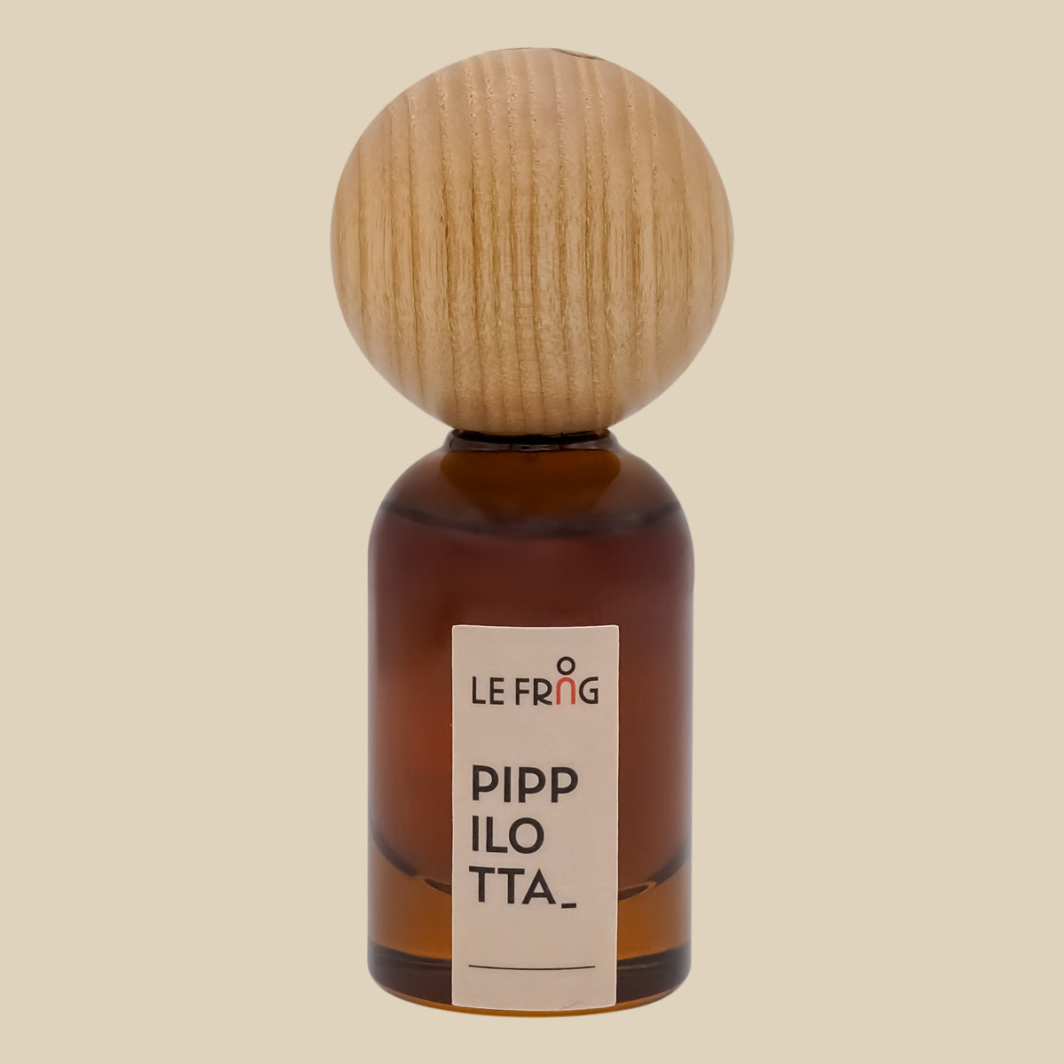 Le Frag Pippilotta perfume bottle with wooden cap on a beige background